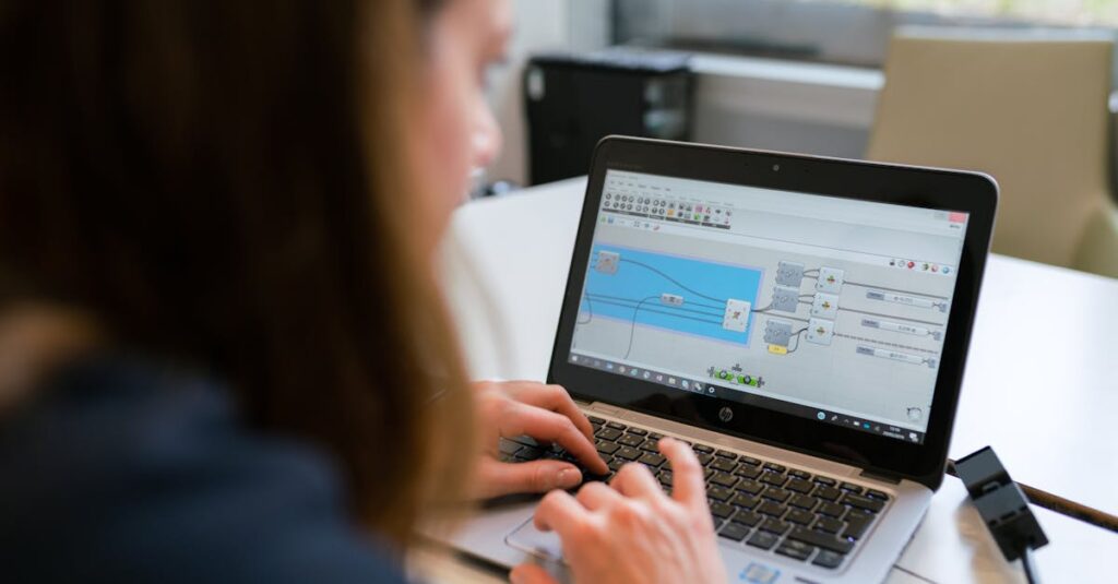 A woman engineer focuses on software analysis using a laptop indoors.